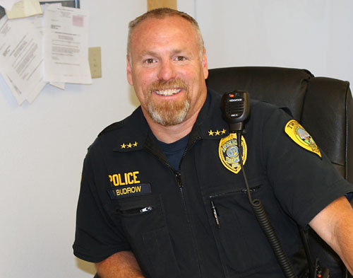 photo of police officer in uniform at desk