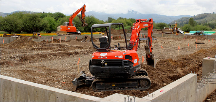 photo of excavators working on new foundation