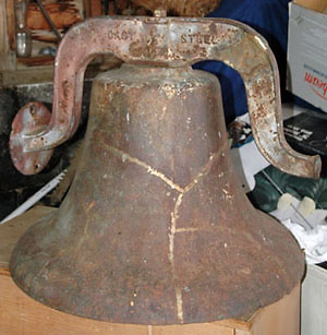 photo of old school bell showing repair seams