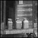 old photo of milk cans on a loading dock